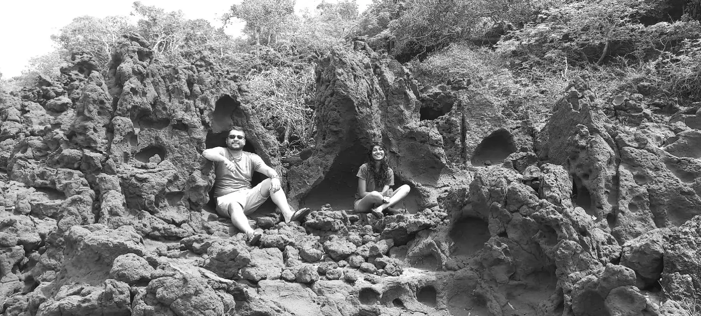 Anjallee and Arran Sivarajah seated among weathered rock formations in Sri Lanka
